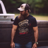 Josh Tyler wearing the Strength Punishes, Cleverness Kills T shirt while standing in front of a truck tail gate.