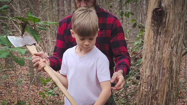 Father and young son in forest during fall, father guiding his son in chopping a tree with an axe, symbolizing passing knowledge, living in the moment, and building a legacy through shared action.