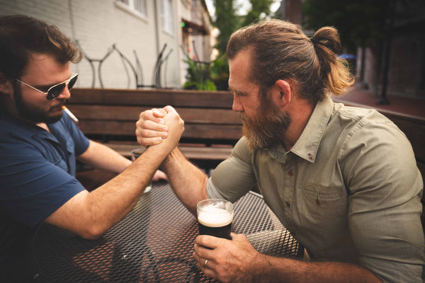 Everyman Shirt dusty olive arm wrestling in cafe