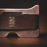 Close up of Savage Gentleman "Razor and Knuckles" logo that's machined into copper.