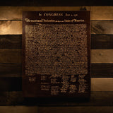 Leather Declaration of Independence hanging on a wood wall by Savage Gentleman. 