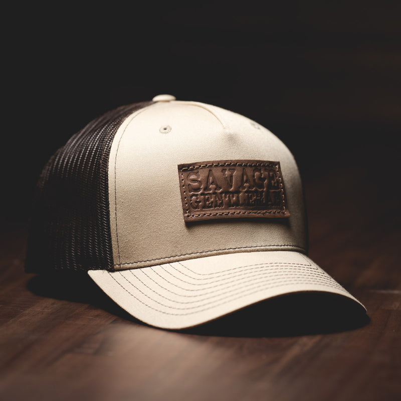 Savage Gentleman Leather Patch Trucker Hat in coffee mesh and sand.